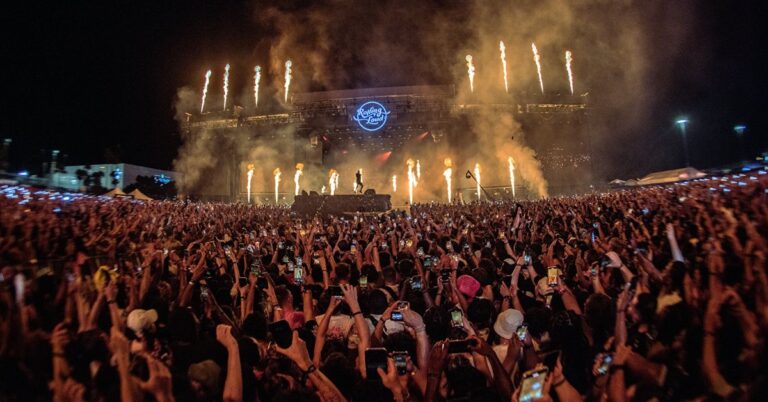 Rolling Loud Australia stage at sunset with large audience and vibrant hip-hop festival atmosphere