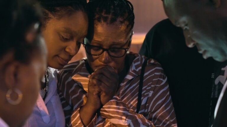 A group of diverse neighbors smiling and interacting at a community event, showcasing the qualities of a perfect neighbor in a harmonious neighborhood.