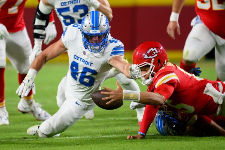 Patrick Mahomes throws a touchdown pass under pressure in the Chiefs vs Lions game on October 12, 2025.