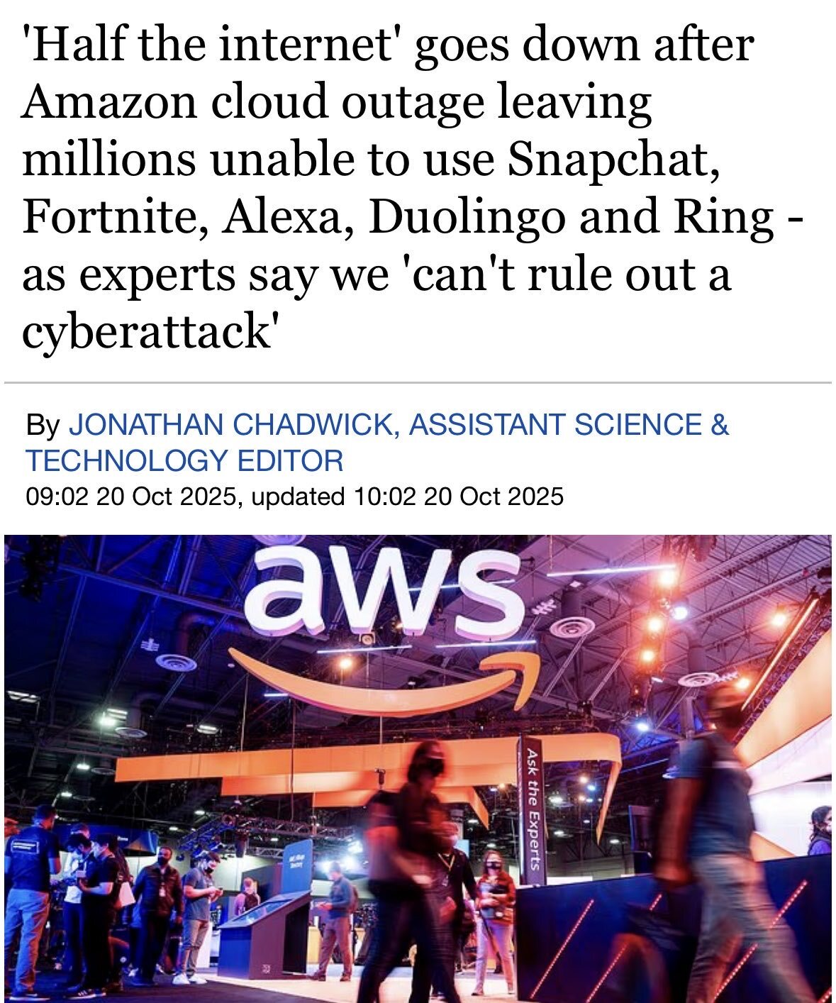 A news headline screenshot from The New York Times dated October 20, 2025, reading 'Amazon’s AWS Disruption Creates Outages for Hundreds of Websites for Hours.' The background shows a blurred image of the AWS pavilion at a trade fair in Hanover, Germany, with blue and white branding. Red error icons and outage alerts overlay the screen, symbolizing widespread internet disruptions affecting services like Snapchat, Venmo, and United Airlines due to a network issue in AWS's US-EAST-1 data center in Northern Virginia