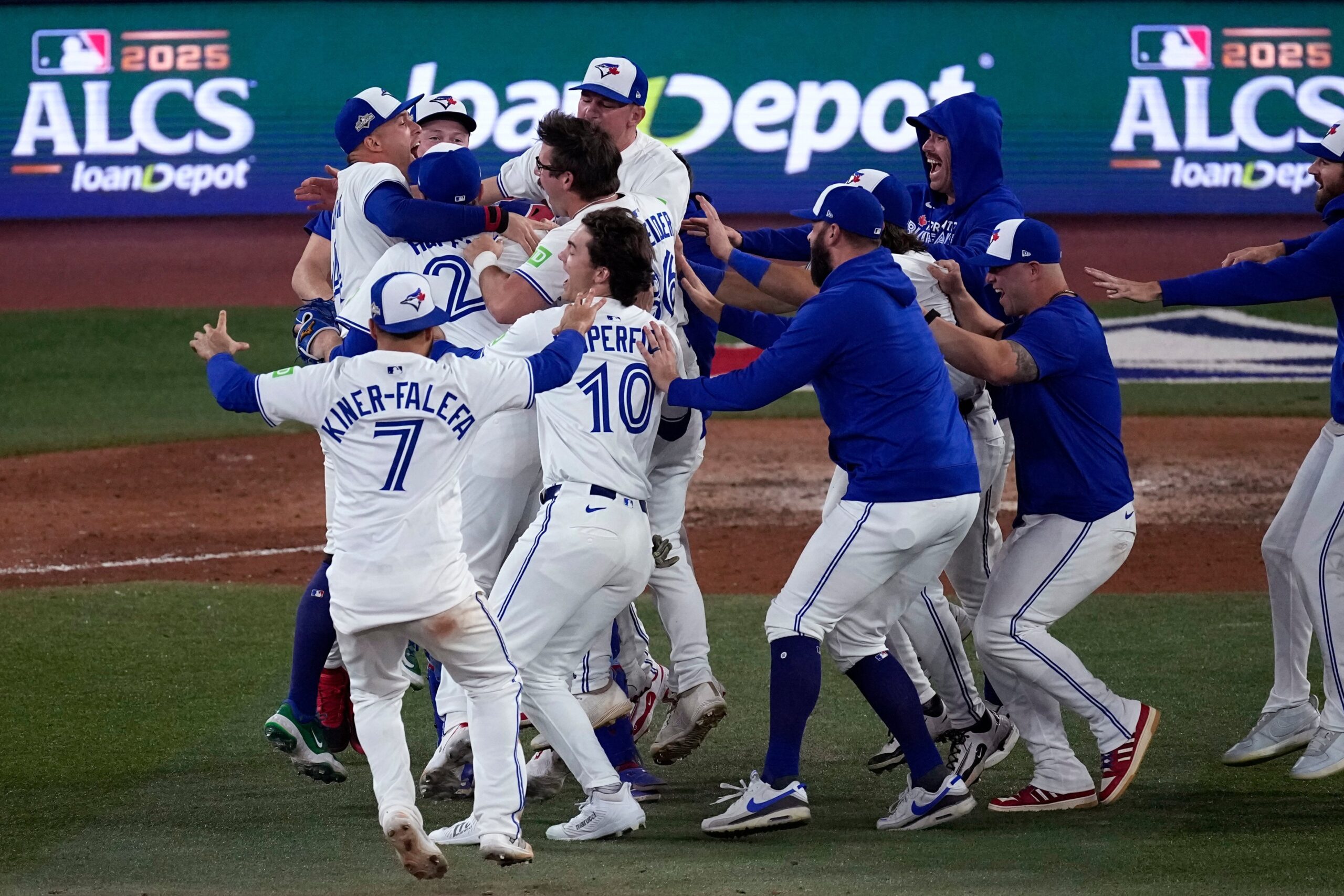 **Alt Text:** Mariners vs Blue Jays players in action during a thrilling baseball matchup at T-Mobile Park.