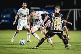 Players from Santos and EC Vitória battle for possession during a high-intensity Brazilian football match