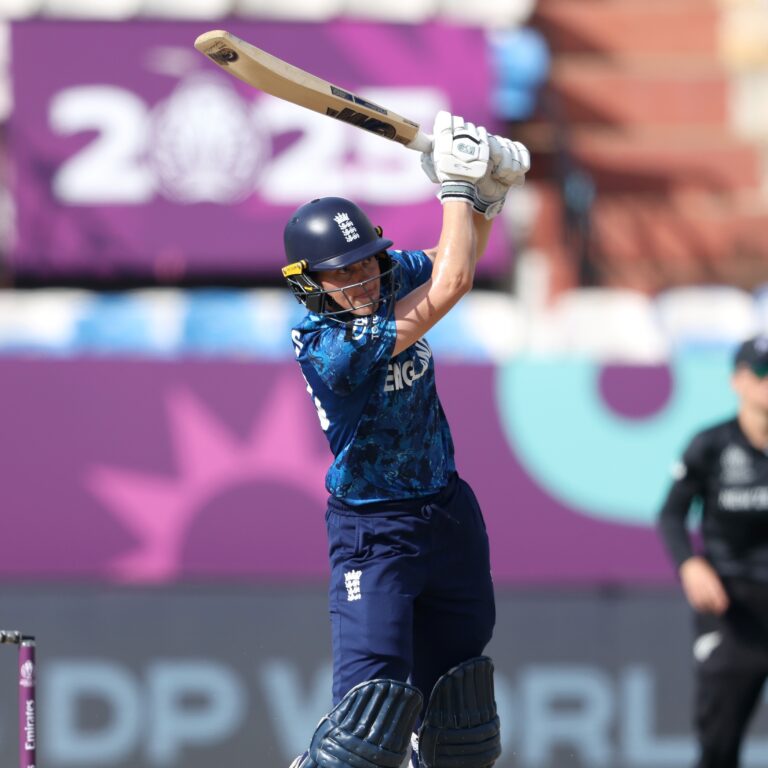 New Zealand and England women’s cricket teams playing an international match, with players in action on the pitch and crowd watching in the stadium