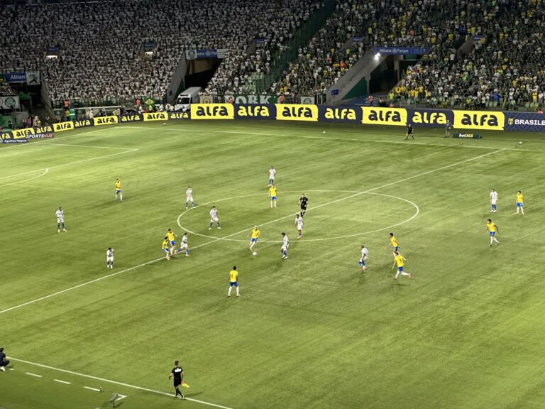 Packed football stadium with Palmeiras and Cruzeiro fans waving flags during a thrilling match