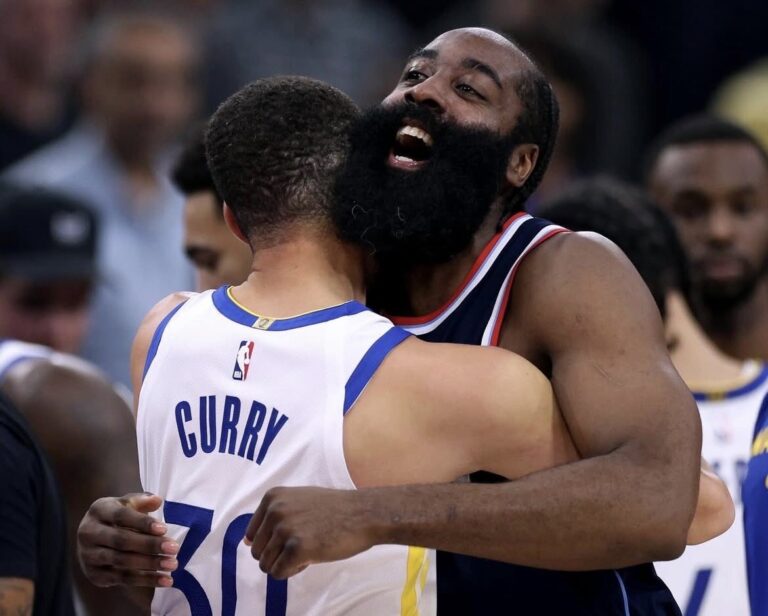 Clippers vs Warriors players battling on the basketball court during an intense NBA game