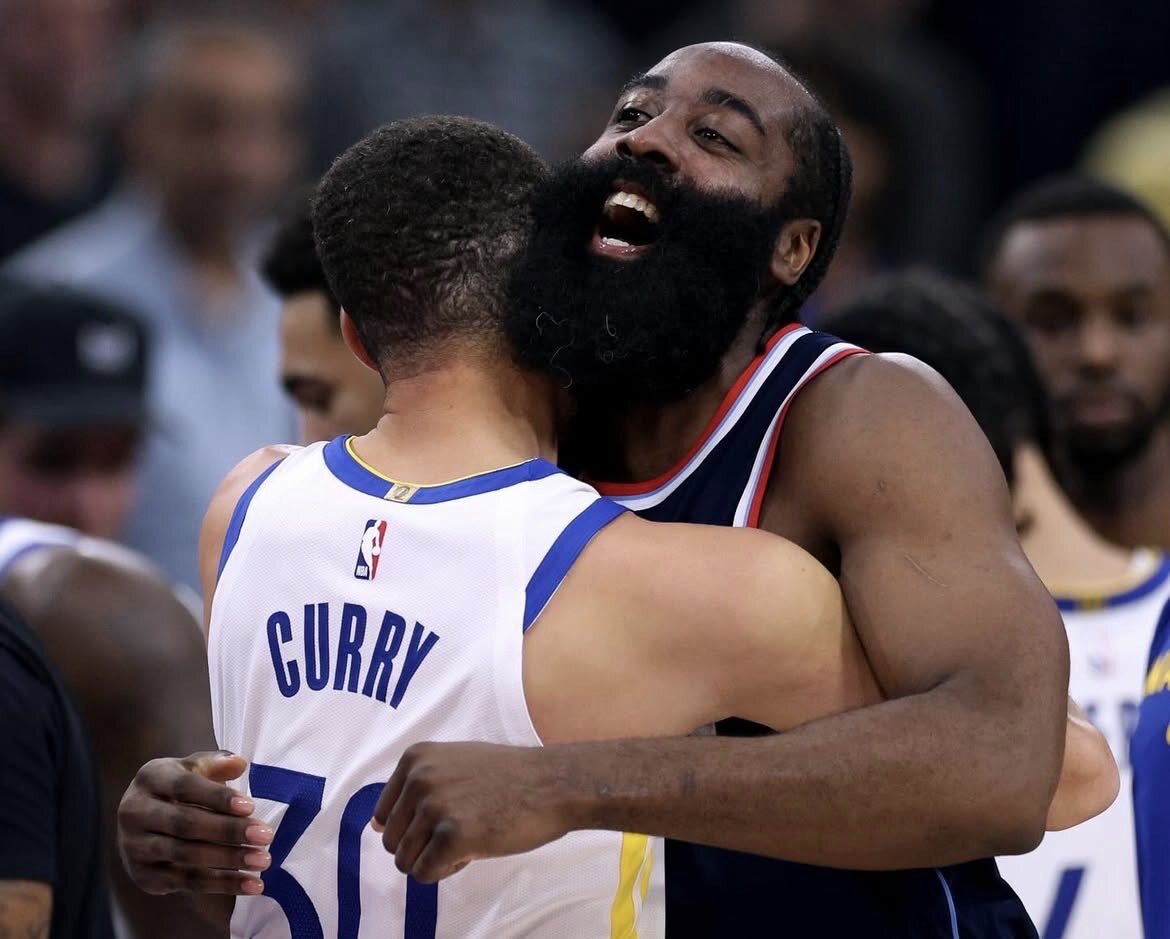 Clippers vs Warriors players battling on the basketball court during an intense NBA game