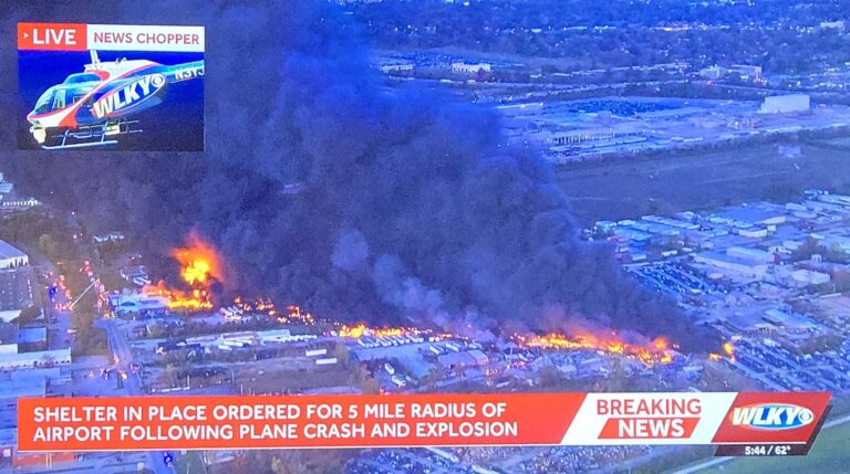Smoke rises after the UPS plane crash Louisville near the airport runway.